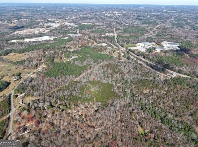 a view of a field with trees and bushes
