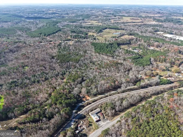 a view of a dry yard with trees and stairs