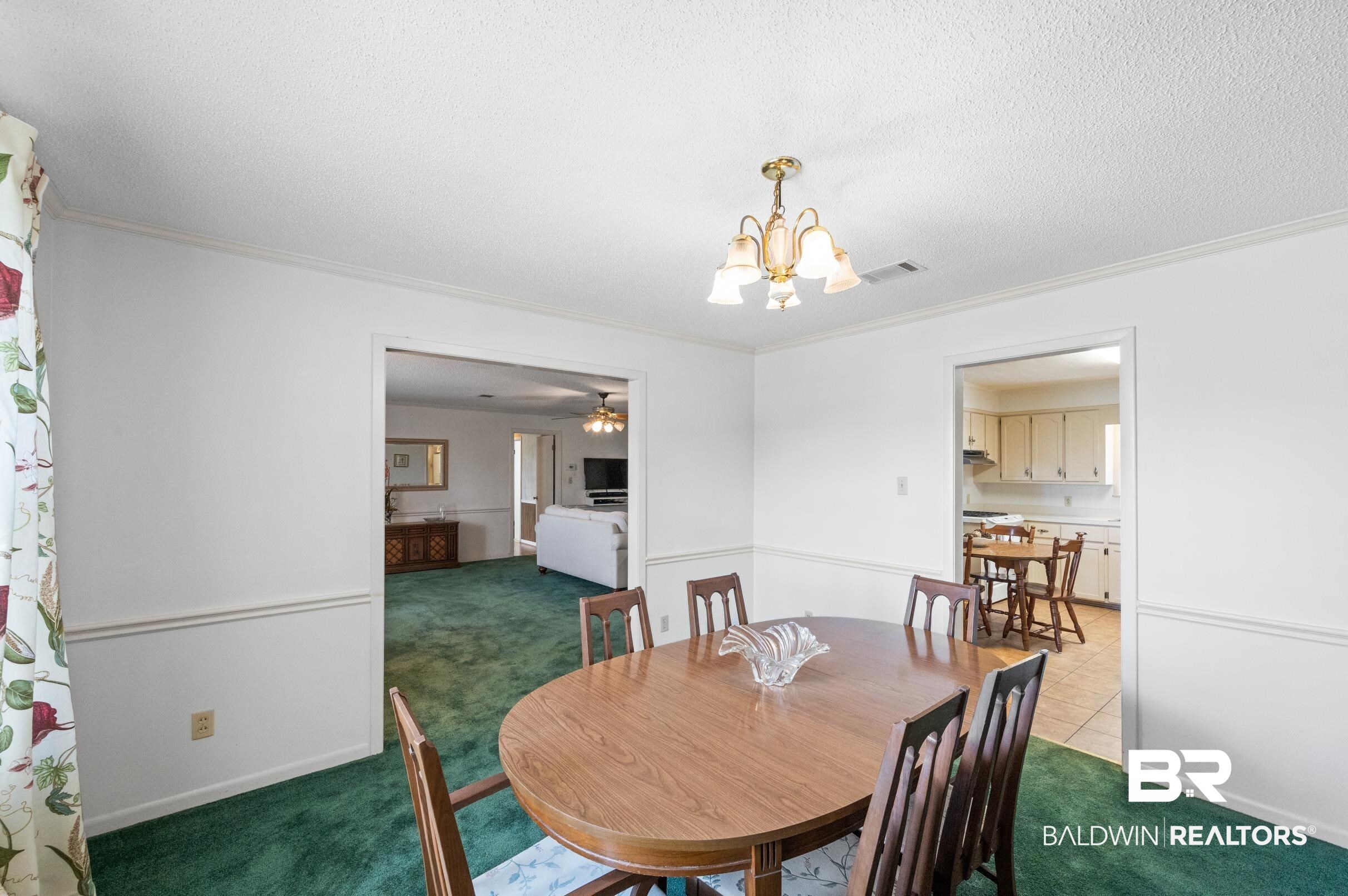 15600 Fackler Road Loxley, AL 36551 - Photo 6 of 51 Dining room featuring a textured ceiling, carpet floors, ceiling fan with notable chandelier, and ornamental molding