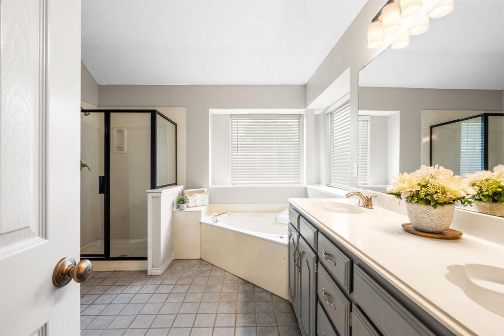 2302 Randi Road Rowlett, TX 75088 - Photo 17 of 33 a bathroom with a tub sink and mirror