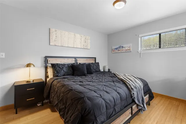 a bed sitting in a bedroom next to a window