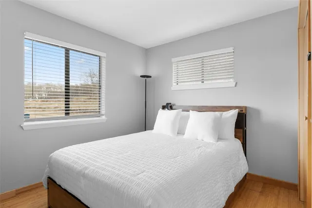 a large bed sitting in a bedroom next to a window