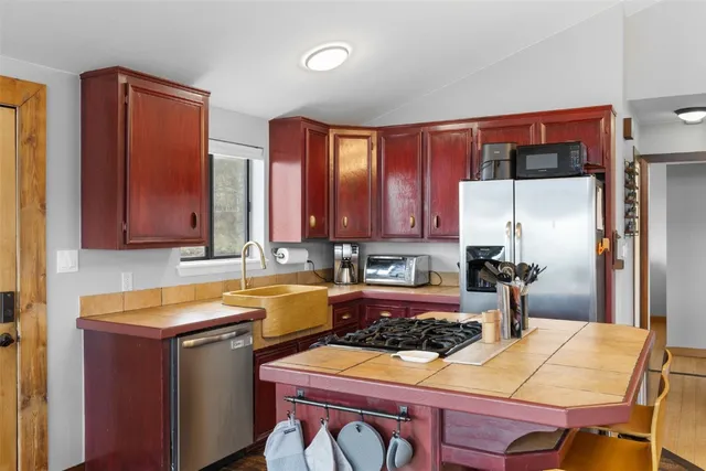 a kitchen with a refrigerator stove and sink