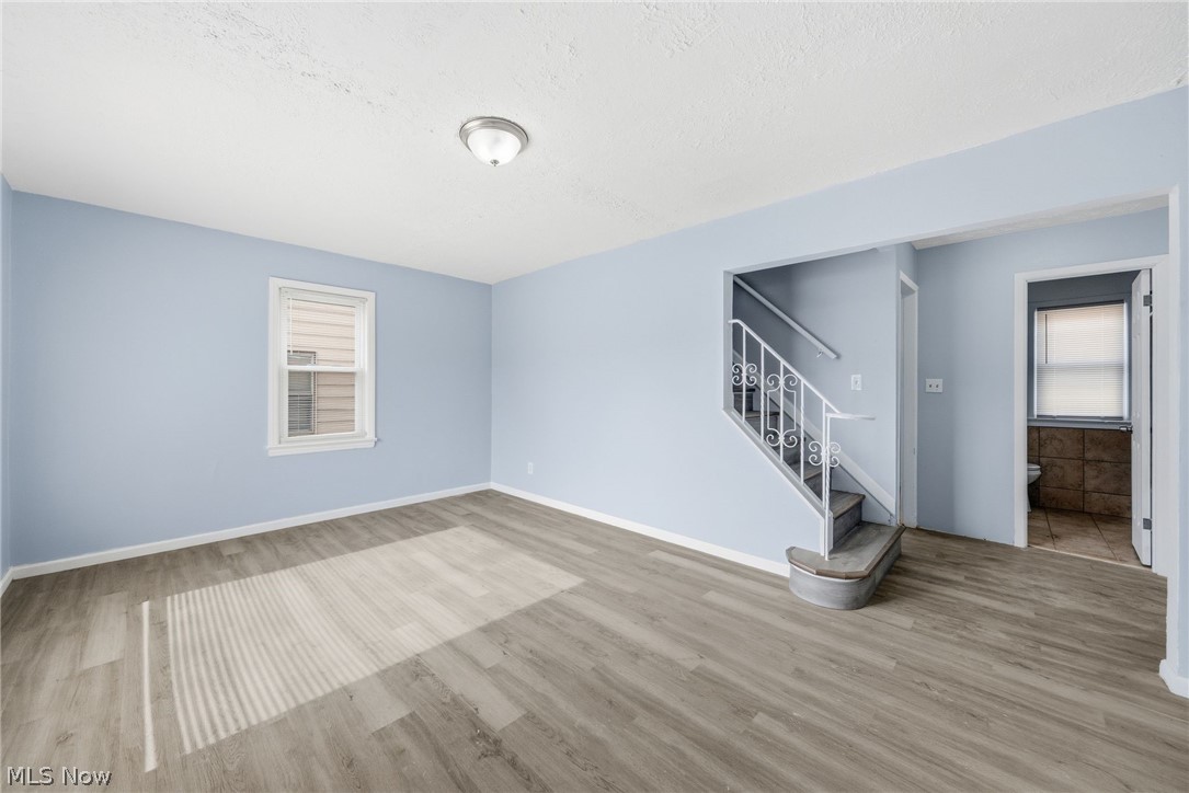 20705 Hansen Road Maple Heights, OH 44137 - Photo 4 of 24 Empty room with light wood-style flooring and a textured ceiling