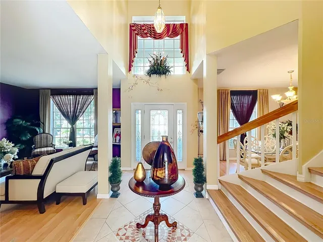 a kitchen with stainless steel appliances kitchen island granite countertop a table and chairs in it