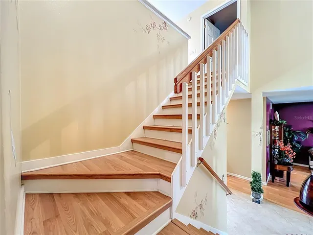 an aerial view of a house with a yard and a large tree