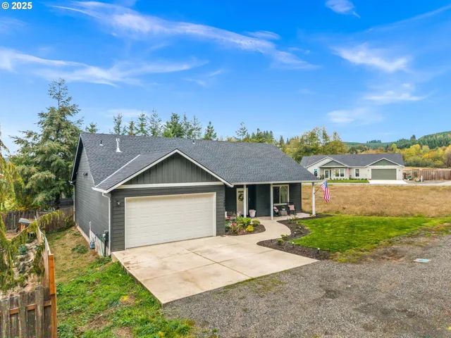 a front view of a house with a garden and yard