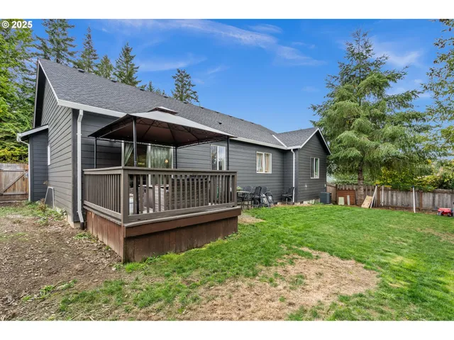 a backyard of a house with table and chairs