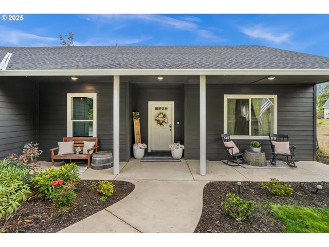 a front view of a house with sitting area