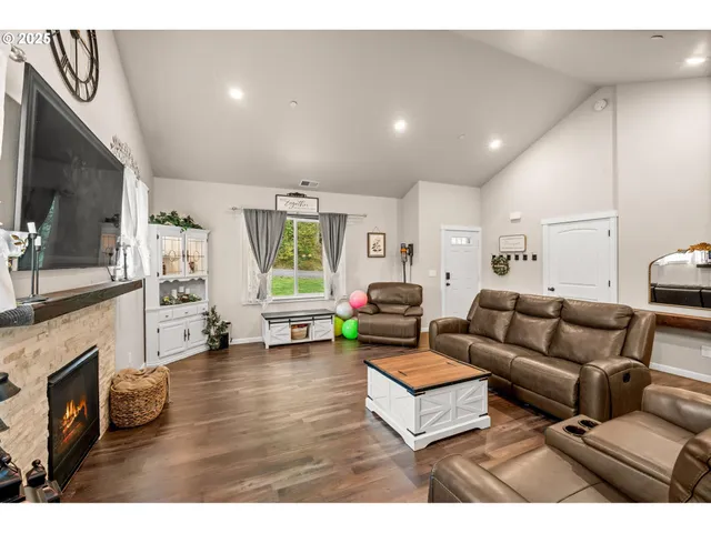 a living room with furniture a fireplace and a flat screen tv