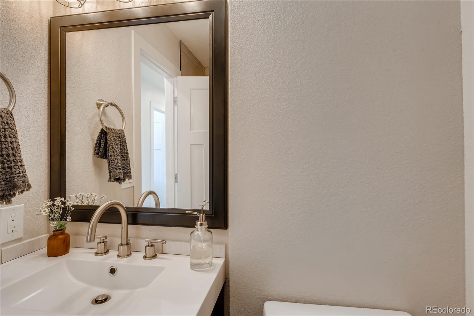3530 East Orchard Road Centennial, CO 80121 - Photo 16 of 35 a bathroom with a sink and a mirror