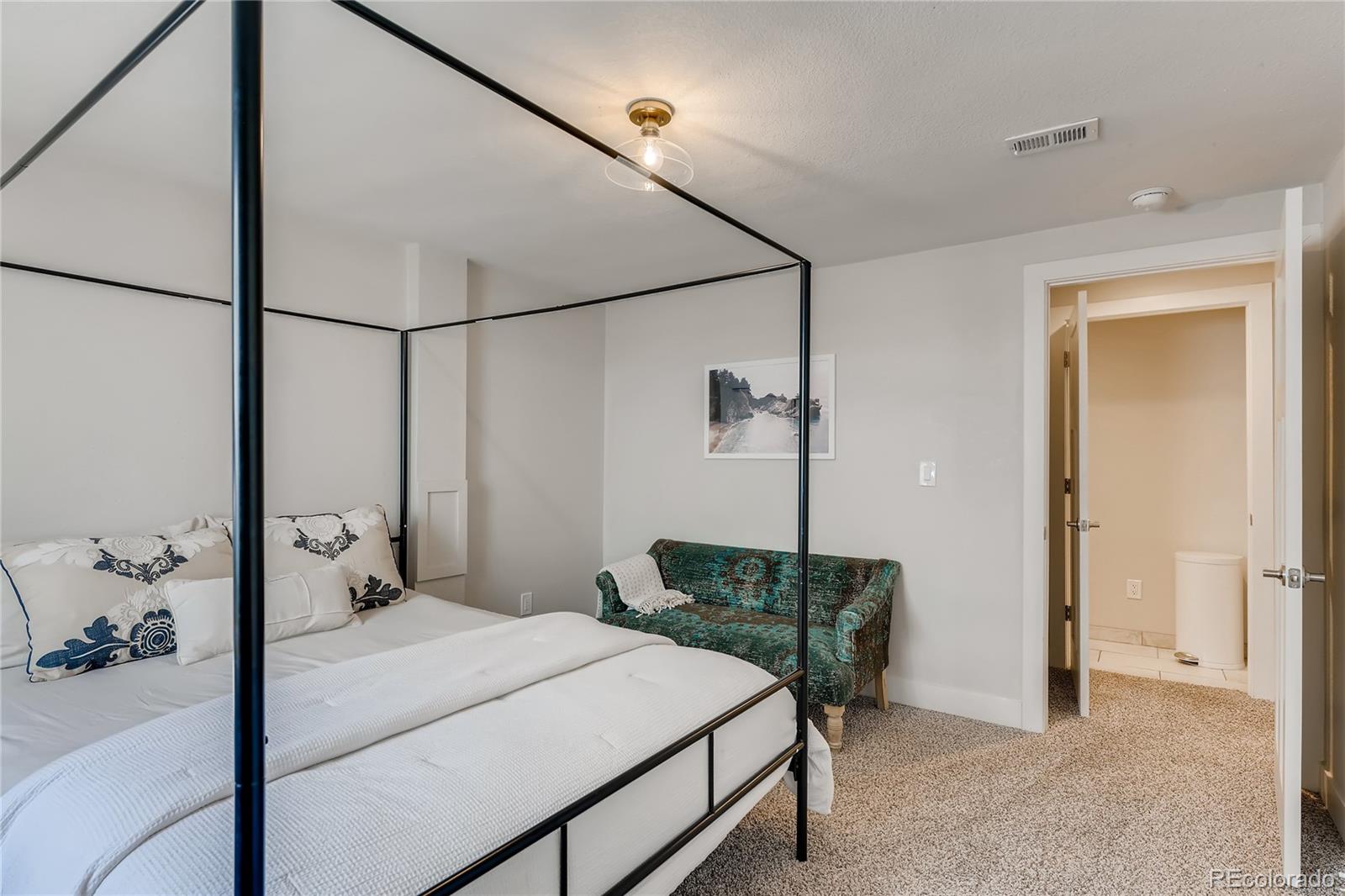 3530 East Orchard Road Centennial, CO 80121 - Photo 22 of 35 a bedroom with a bed and a chandelier