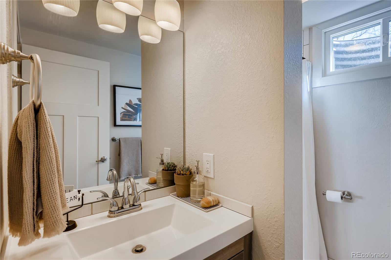 3530 East Orchard Road Centennial, CO 80121 - Photo 26 of 35 a bathroom with a sink vanity and a mirror