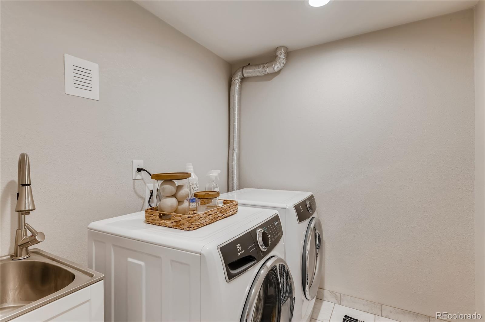 3530 East Orchard Road Centennial, CO 80121 - Photo 29 of 35 a kitchen with a sink a stove and cabinets