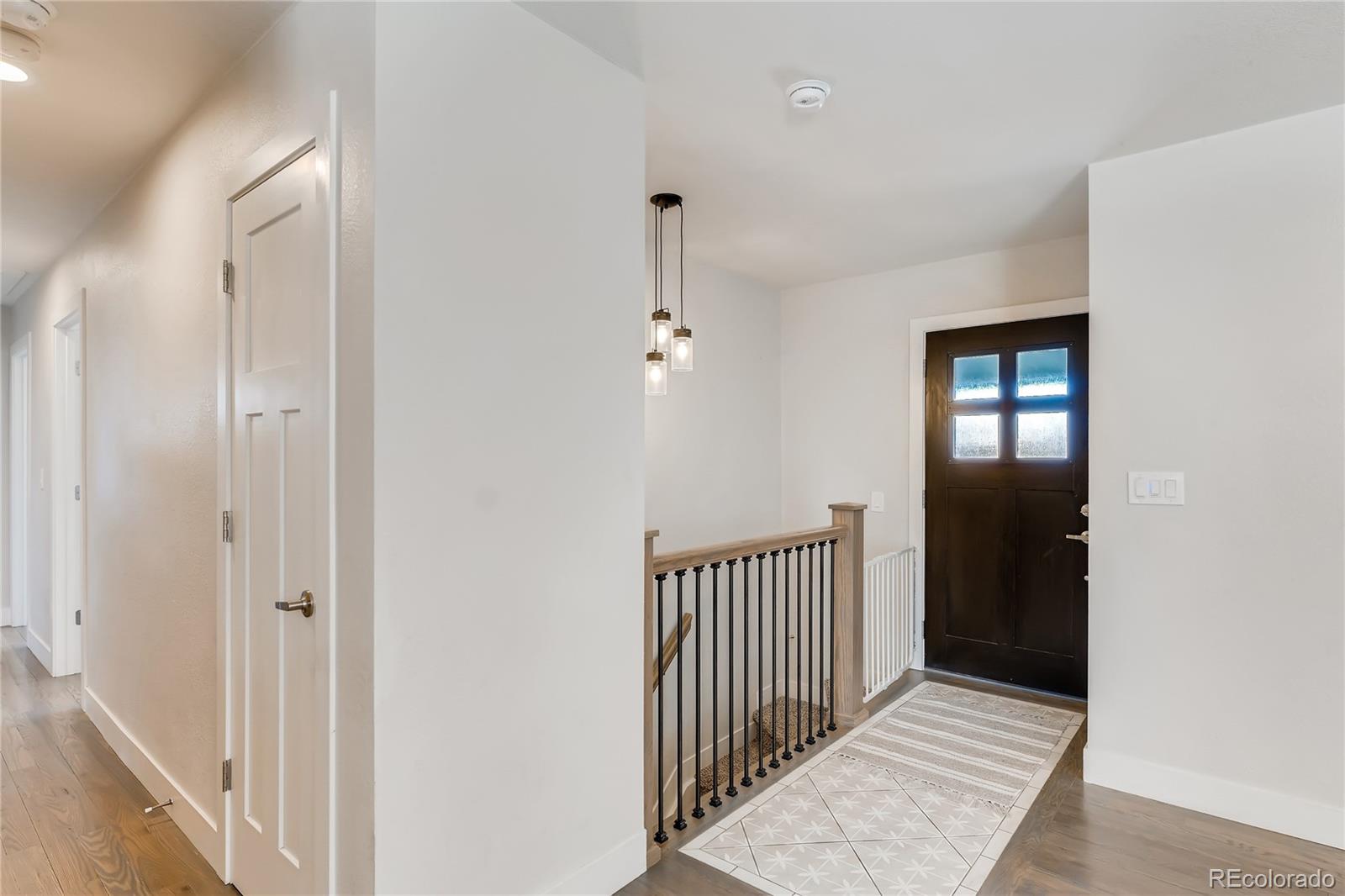 3530 East Orchard Road Centennial, CO 80121 - Photo 35 of 35 a view of a hallway with wooden floor and a bathroom