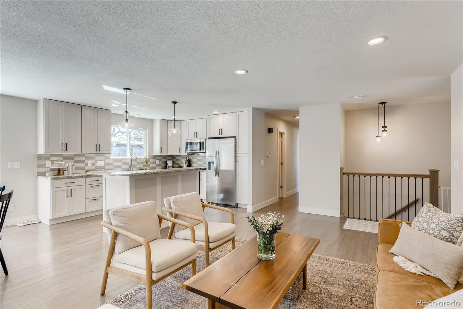 3530 East Orchard Road Centennial, CO 80121 - Photo 4 of 35 a kitchen with white cabinets and stainless steel appliances