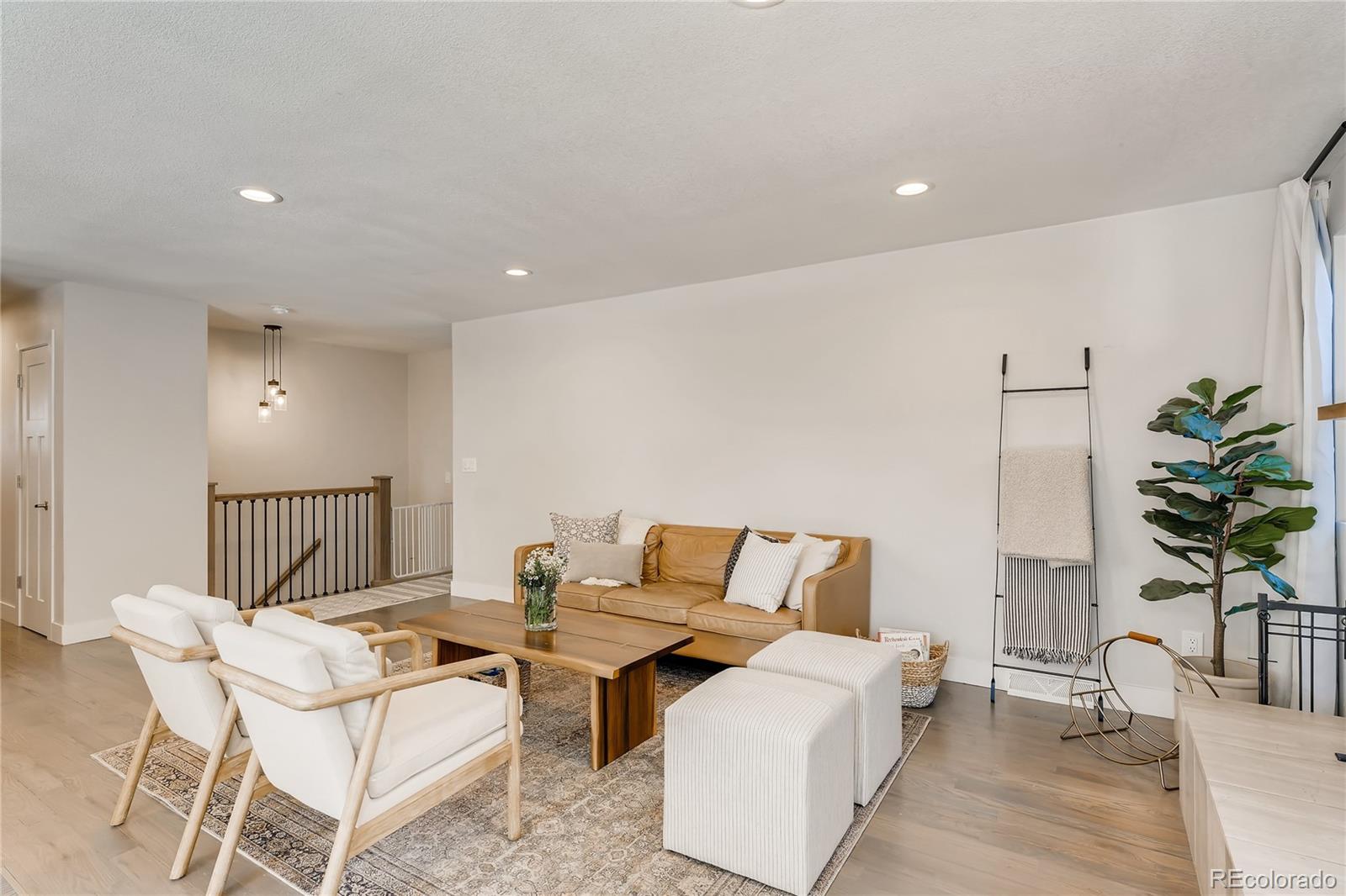 3530 East Orchard Road Centennial, CO 80121 - Photo 6 of 35 a living room with furniture and potted plant