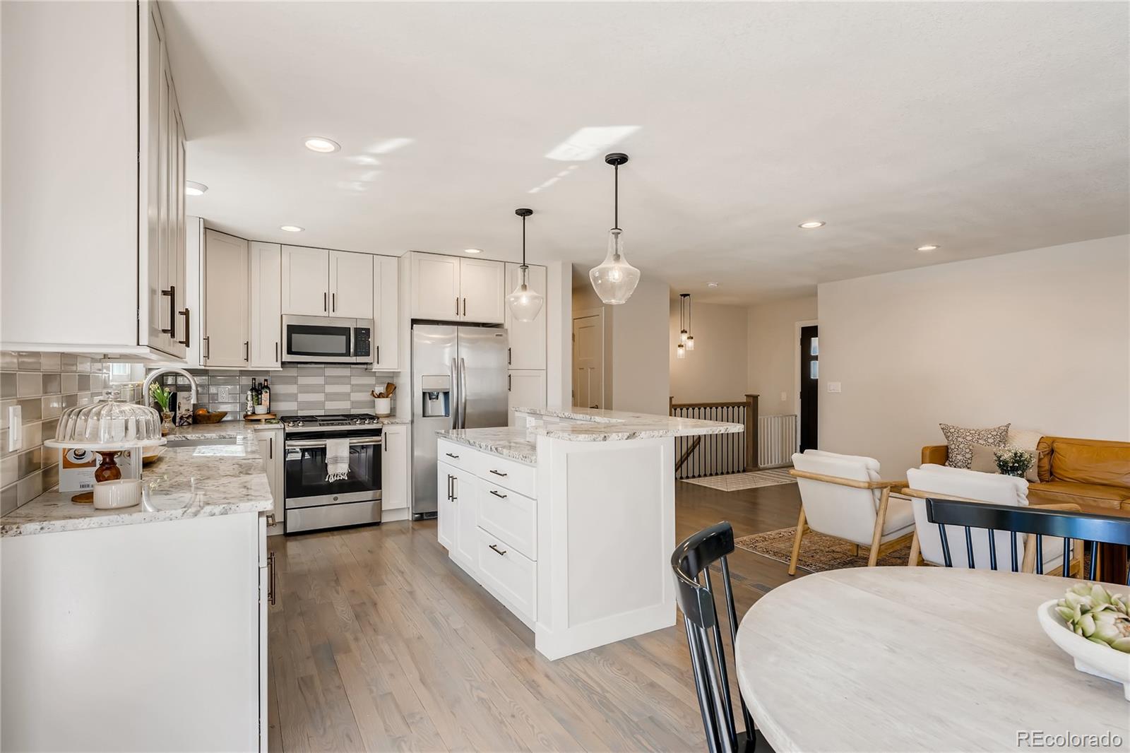 3530 East Orchard Road Centennial, CO 80121 - Photo 8 of 35 a kitchen with white cabinets and stainless steel appliances