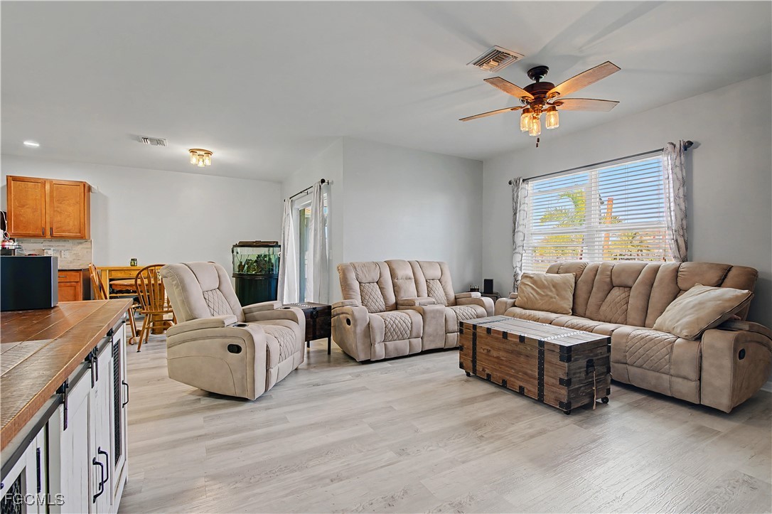 2613 Manzilla Lane Cape Coral, FL 33909 - Photo 12 of 42 a living room with furniture and a flat screen tv
