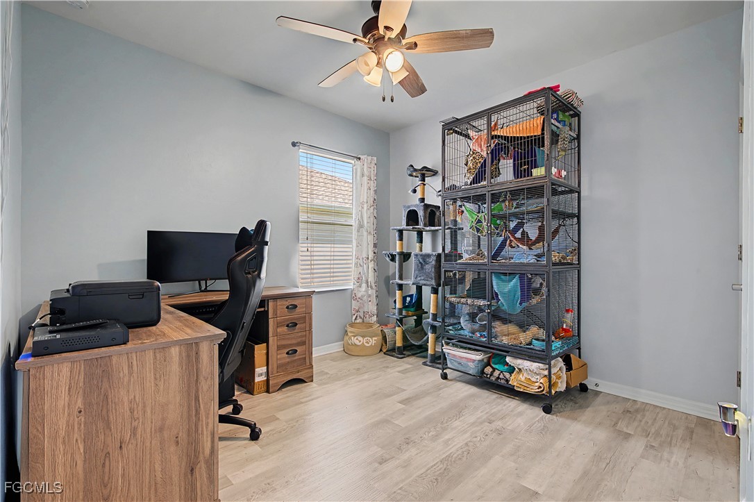 2613 Manzilla Lane Cape Coral, FL 33909 - Photo 19 of 42 a view of a workspace with furniture and a window