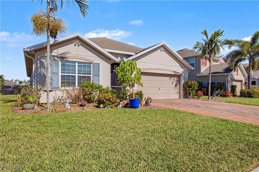 2613 Manzilla Lane Cape Coral, FL 33909 - Photo 2 of 42 a front view of house with yard and outdoor seating