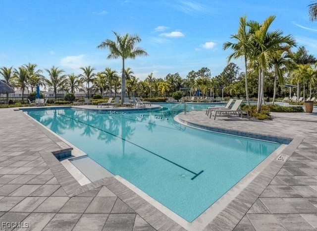 2613 Manzilla Lane Cape Coral, FL 33909 - Photo 29 of 42 a view of a swimming pool with a table and chairs
