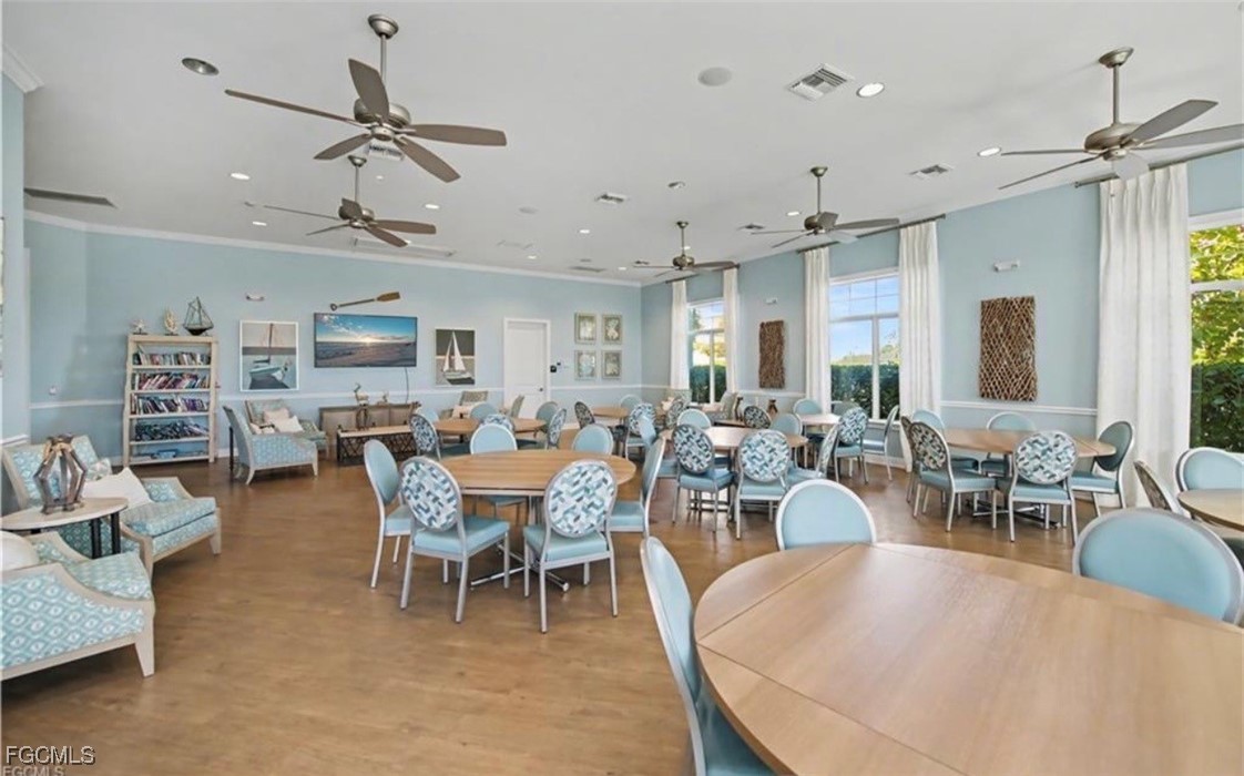 2613 Manzilla Lane Cape Coral, FL 33909 - Photo 37 of 42 a view of a dining room and livingroom with furniture wooden floor a chandelier