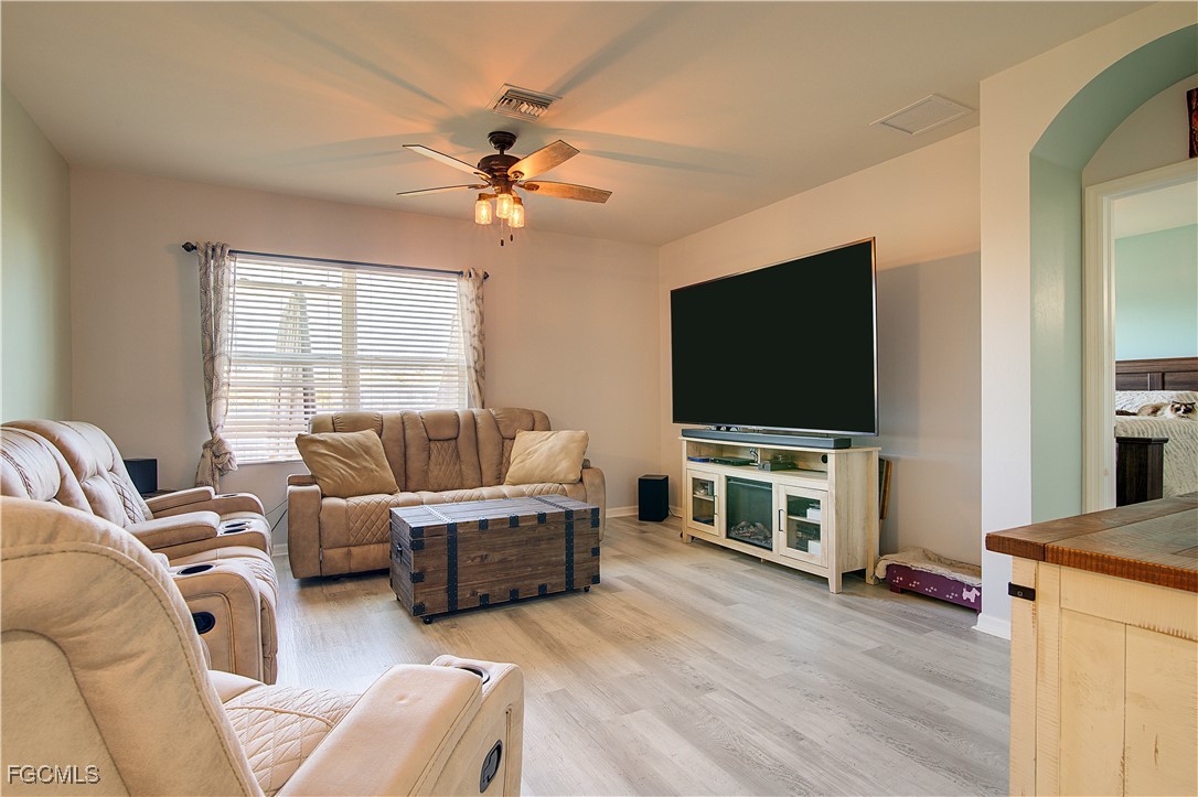 2613 Manzilla Lane Cape Coral, FL 33909 - Photo 10 of 42 a living room with furniture and a flat screen tv