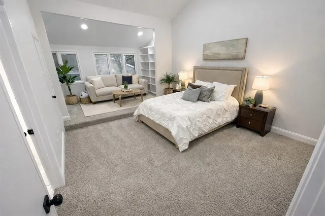 a spacious bedroom with a bed and a couch