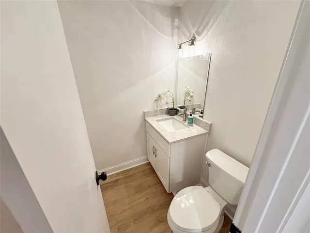 a bathroom with a sink a toilet a mirror and vanity