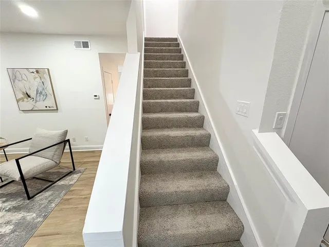 a view of staircase with white walls