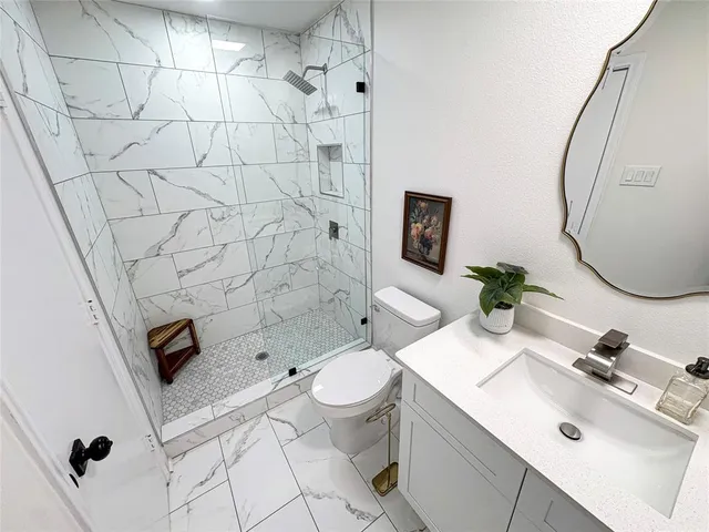 a bathroom with a sink toilet and shower