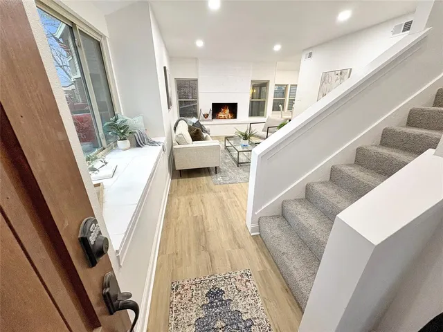 a view of a living room with furniture and a fireplace