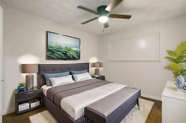 a bedroom with a bed and a potted plant