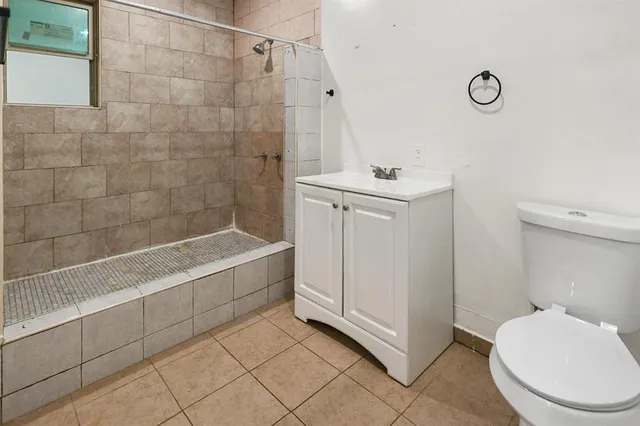 a bathroom with a sink a toilet and a shower