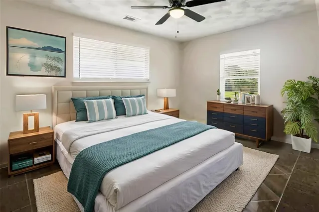 a bedroom with a large bed and a chandelier