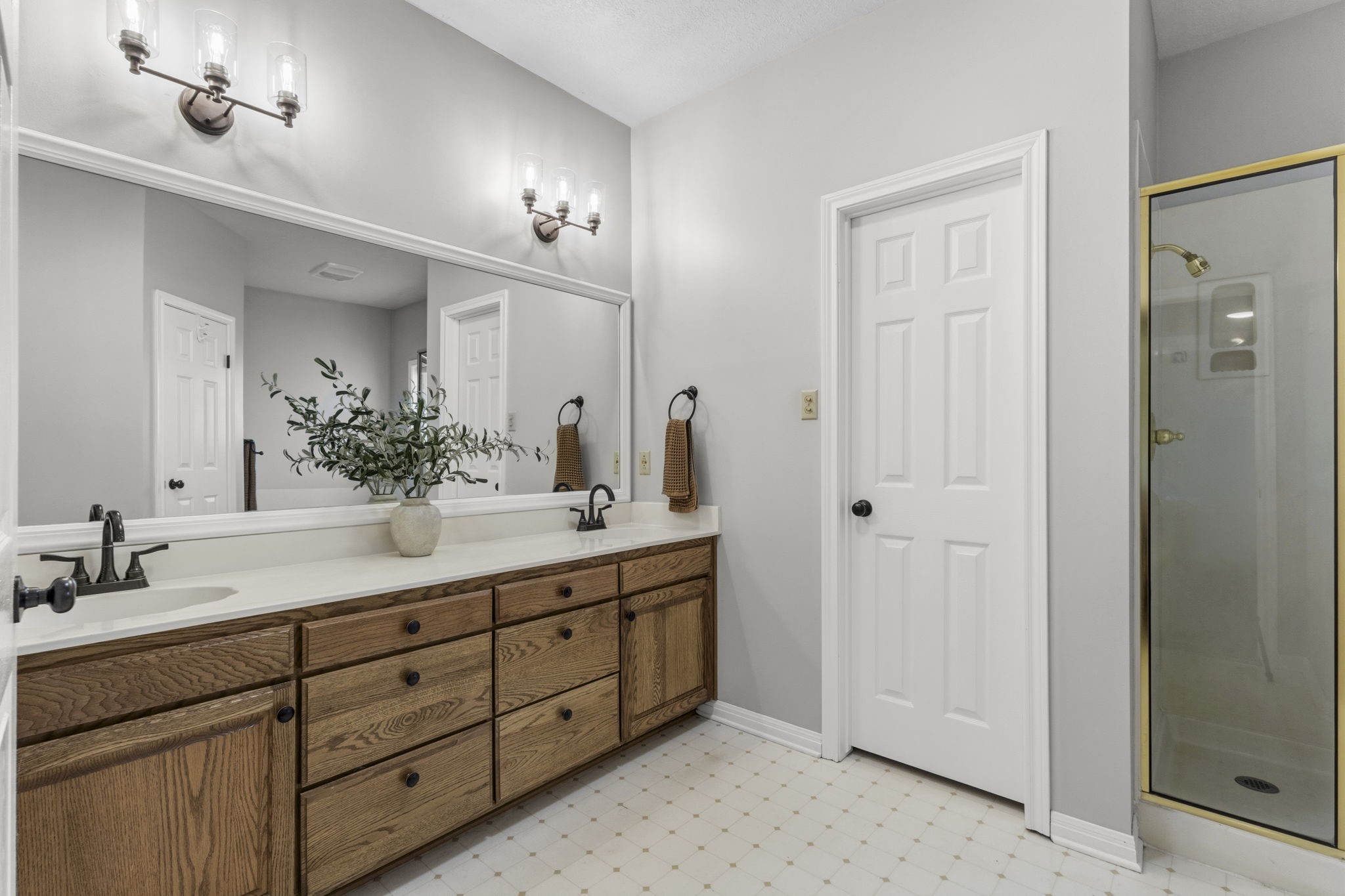 16421 Westbury Road Beaumont, TX 77713 - Photo 14 of 29 a bathroom with double sink and a mirror
