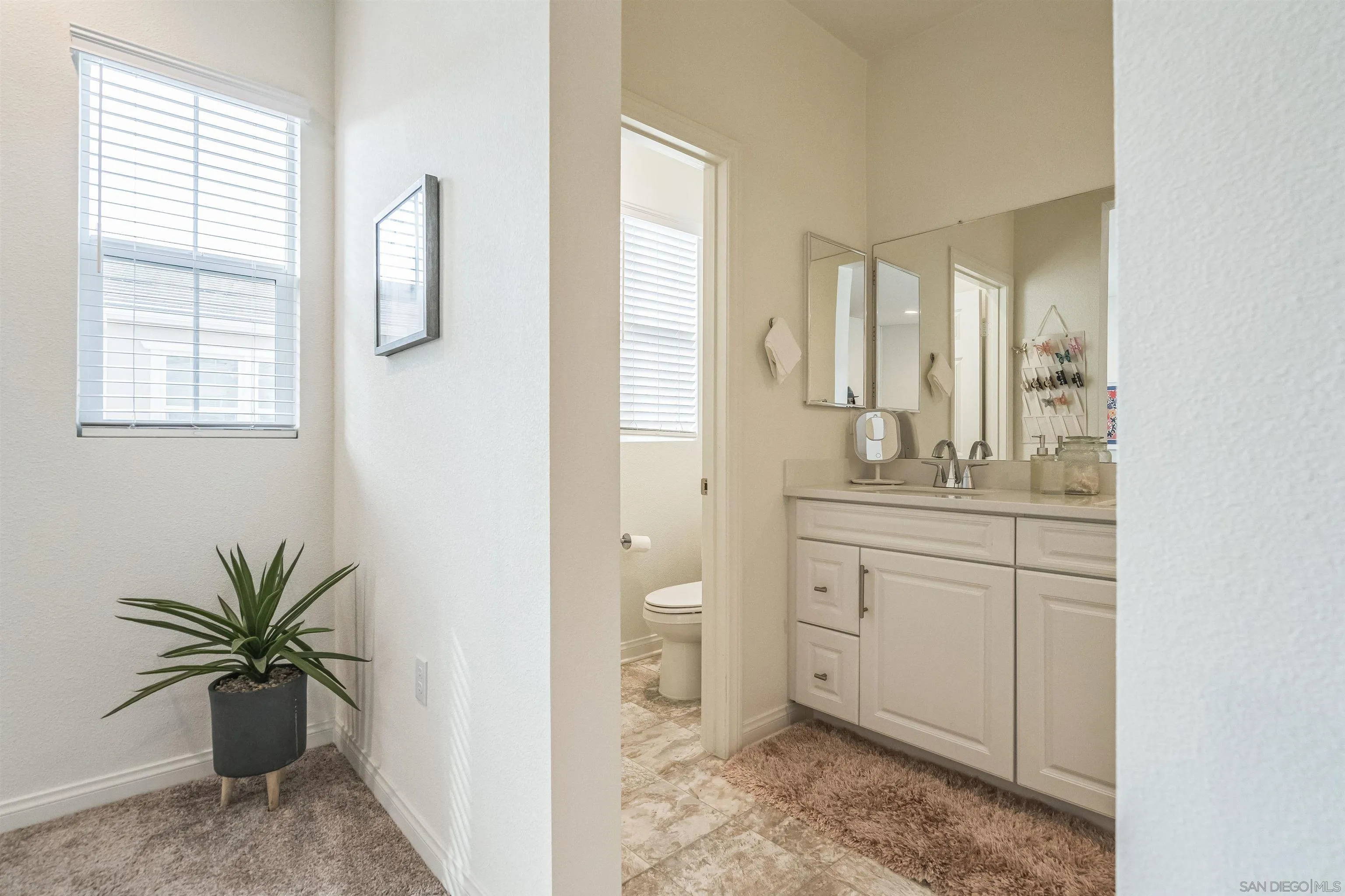 2018 Barite Street Spring Valley, CA 91977 - Photo 30 of 47 a spacious bathroom with a granite countertop sink and a mirror
