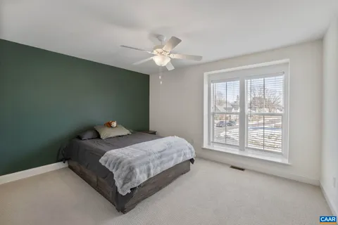 a view of an empty room with a window and cabinet