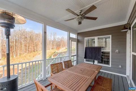 a large living room with stainless steel appliances granite countertop couches a fireplace with wooden floor next to a living room