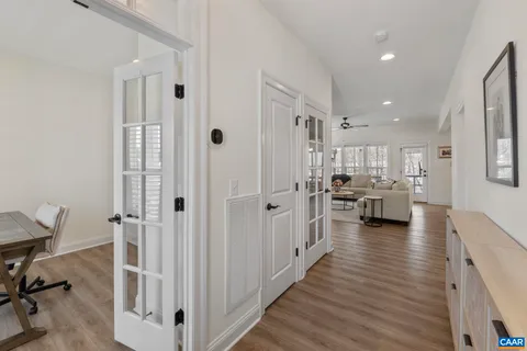 a view of a bedroom with a window and wooden floor