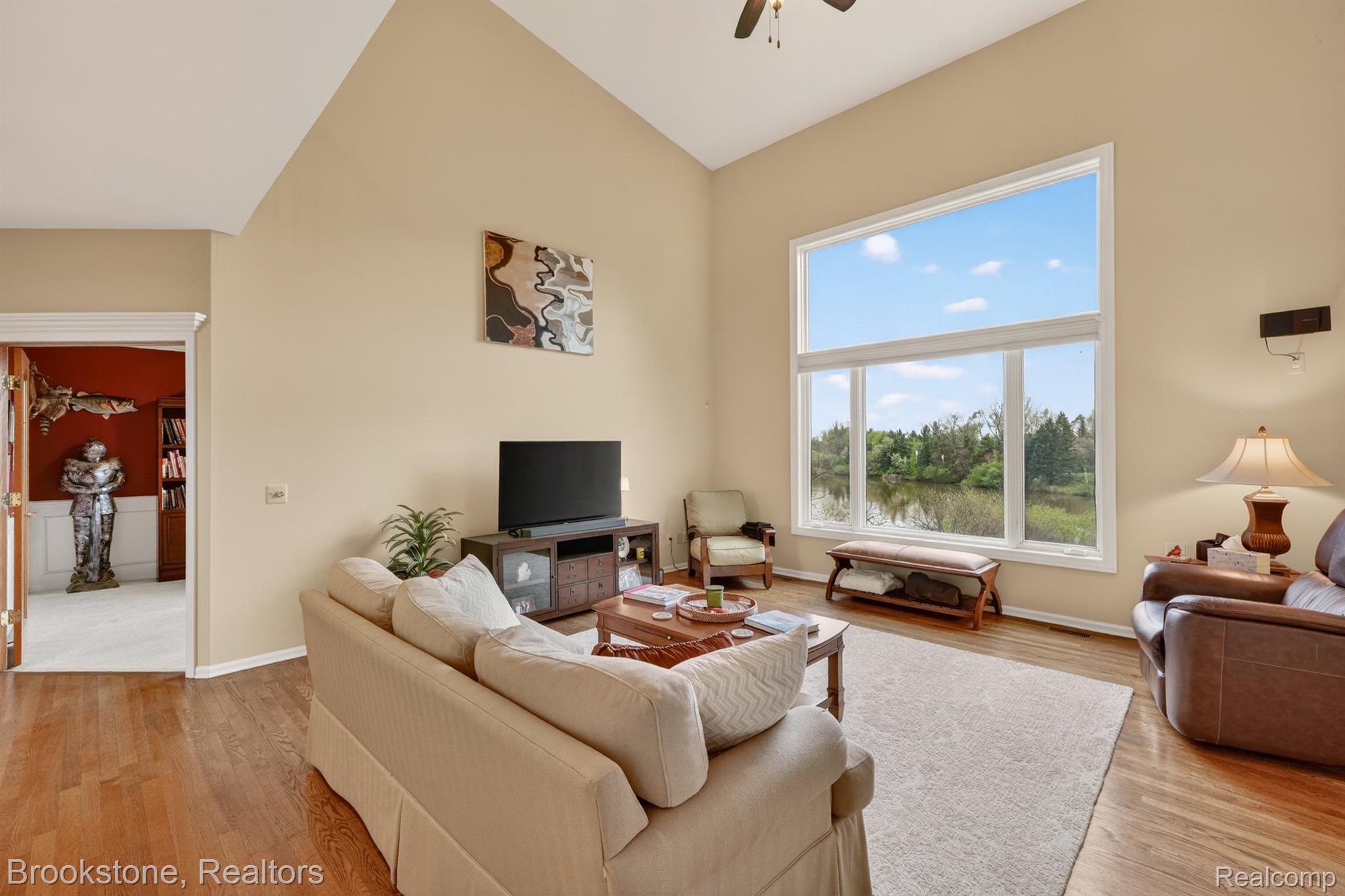 4054 Calumet Drive Rochester, MI 48306 - Photo 19 of 44 Living area featuring ceiling fan, vaulted ceiling, and light wood-style floors