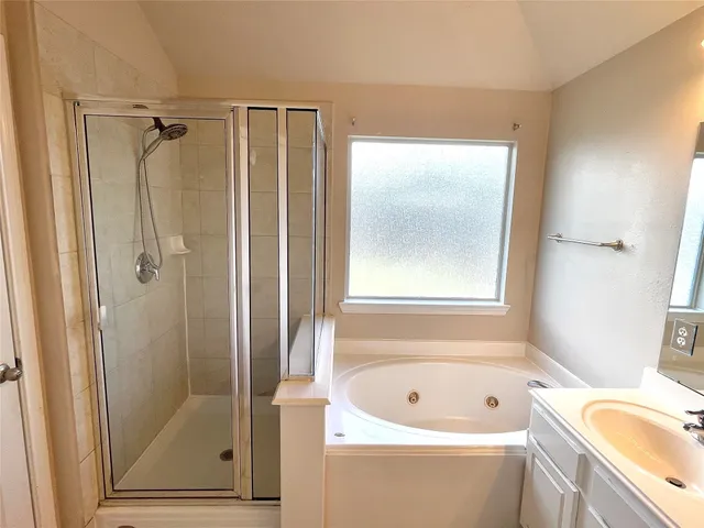 a spacious bathroom with a sink and a mirror