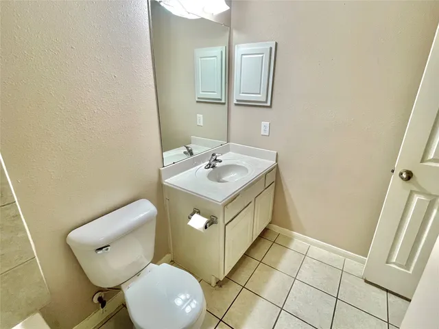a bath tub sitting next to a white sink and a shower