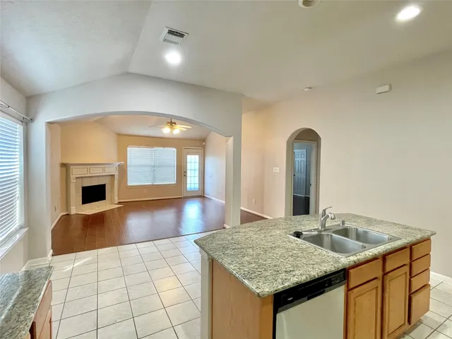 a kitchen with granite countertop a sink and a counter top space