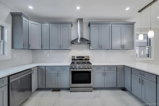a kitchen with stainless steel appliances granite countertop a stove and a sink