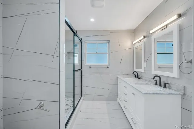 a bathroom with a double vanity sink and mirror
