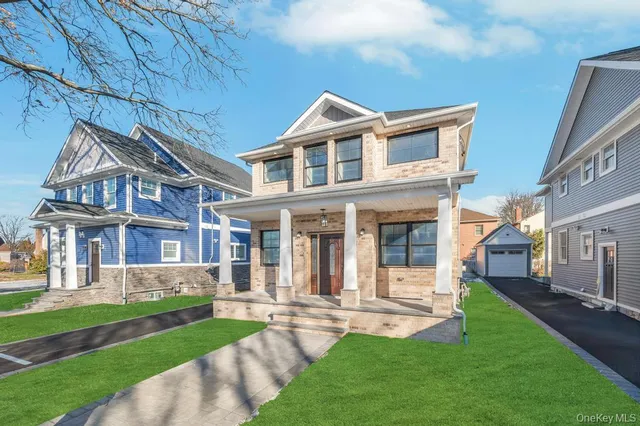 a front view of a house with a yard and porch