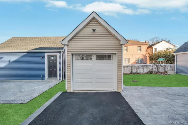 a view of a house with a yard and garage