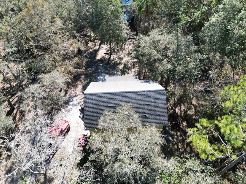 39716 Tworut Road Webster, FL 33597 - Photo 27 of 36 a view of a stone house with a tree